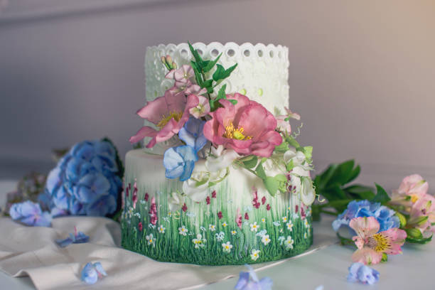 istock Wedding spring cake decorated with colorful flowers and hydrangeas. Desserts for a festive summer mood 926077120