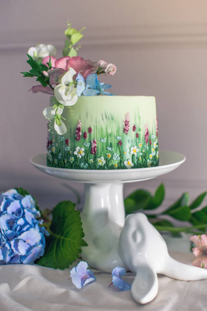istock Wedding spring cake decorated with colorful flowers and hydrangeas. Desserts for a festive summer mood 926077128