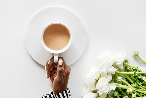 Aerial view of black woman drinks coffee