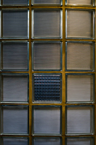 istock Cutout glass block wall half round in retro design with broken pattern repetition 60s look one out of line 926082130