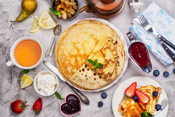 Colorful, tasty and savory breakfast with crepes and different fillings and sauces. Top vie