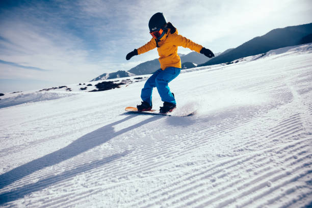 istock snowboarder snowboarding in winter mountains 926083888