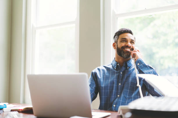 istock Businessman talking on phone at home office 926084656