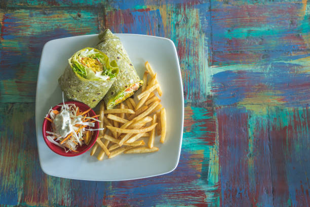 Vegetarian cuisine. Falafel wrap, vegetable salad, and french fries.