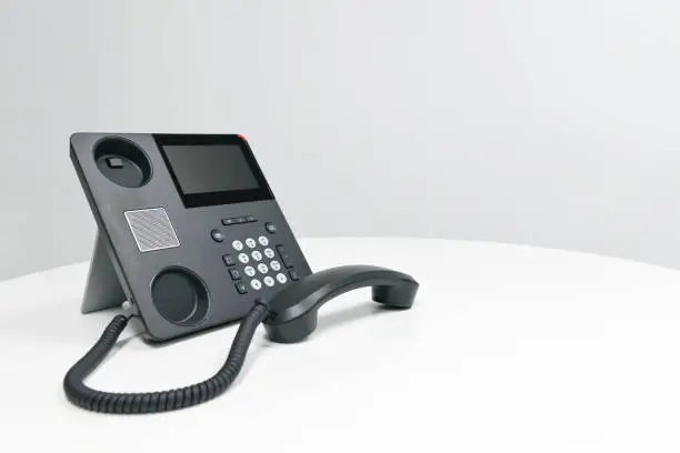 Black IP Phone, Office phone on the white table in the meeting room