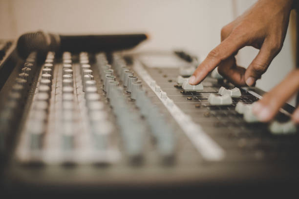 istock Man hands of sound engineer adjusting audio mixing console. 926092106