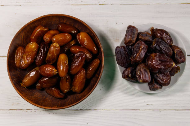 istock Dried dates fruit on white wooden table. Top view 926096650