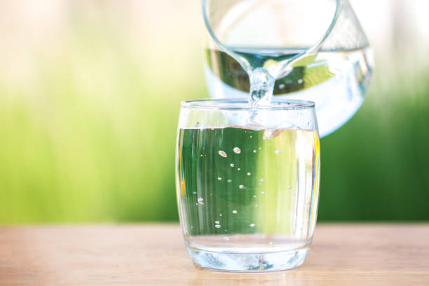 istock Glass of water on nature background. 926098232