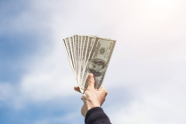 istock Man hand with money on  blue sky cloud  background. 926098524