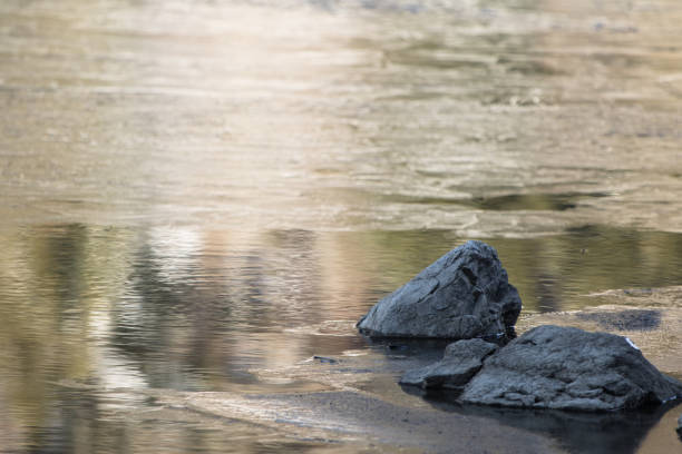 istock close up on rock stone isolated on a lake with reflection 926101702