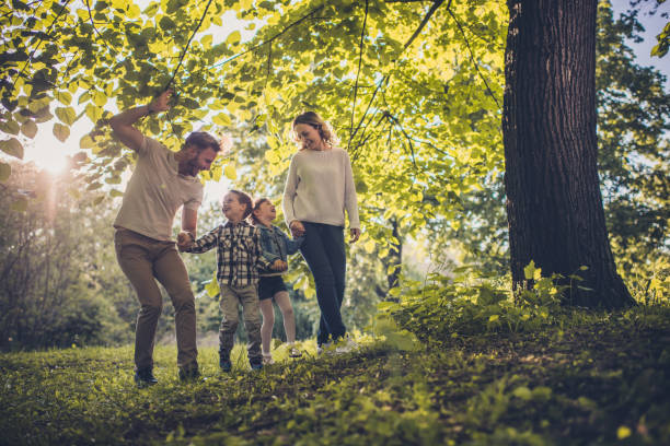 istock Happy family communicating while holding hands in the park. 926102124