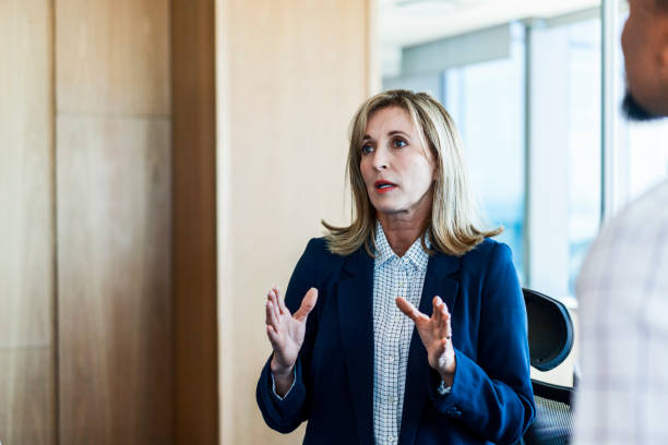 istock Businesswoman explaining male colleagues in office 926110246