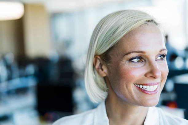 istock Smiling businesswoman looking away at workplace 926110440
