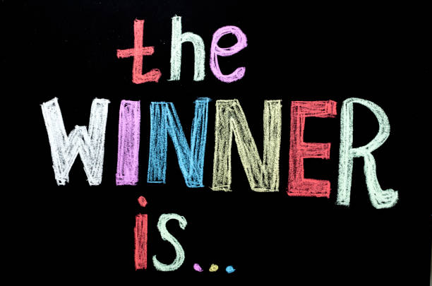 istock colored hand written text 'the winner is ' on chalkboard 926113832