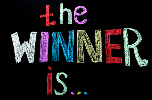 istock colored hand written text 'the winner is ' on chalkboard 926113842