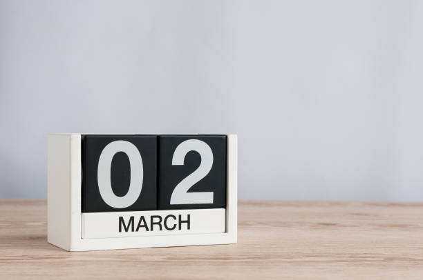 istock March 2nd. Day 2 of month, wooden calendar on light background. Spring time, empty space for text 926114236