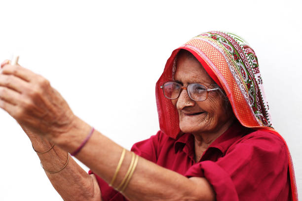 Old indian farmer couple showing thumps up at home