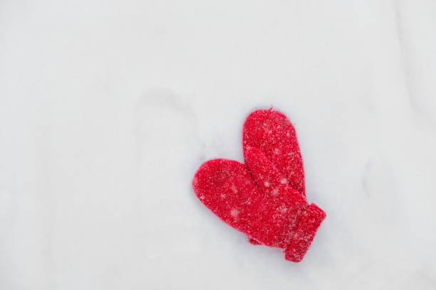 istock red mittens in winter lie on snow during a snowfall 926116714
