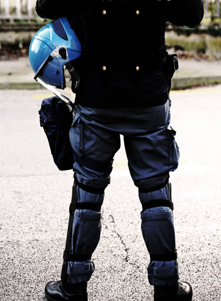 istock policeman with helmets and baton with dark effect 926117278