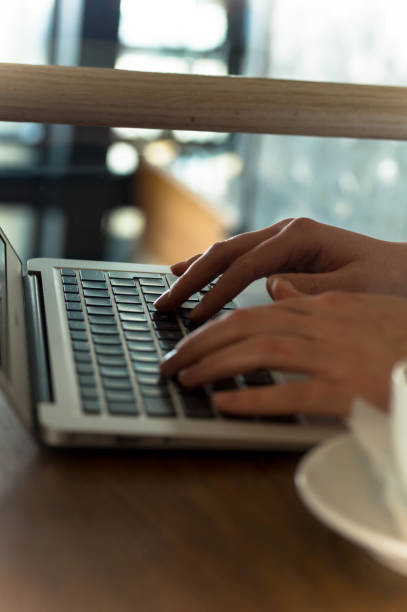 istock Hands typing on laptop computer at coffee shop 926117558