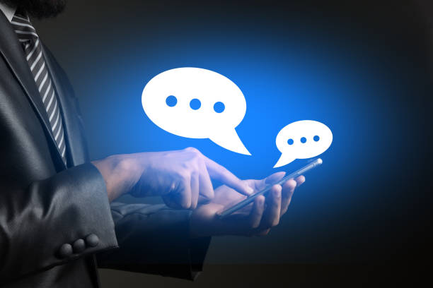 istock Business man using a smartphone, standing with speech bubbles on his phone. 926125716