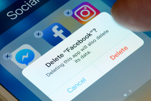 Deleting Facebook App from Smartphone stock photo