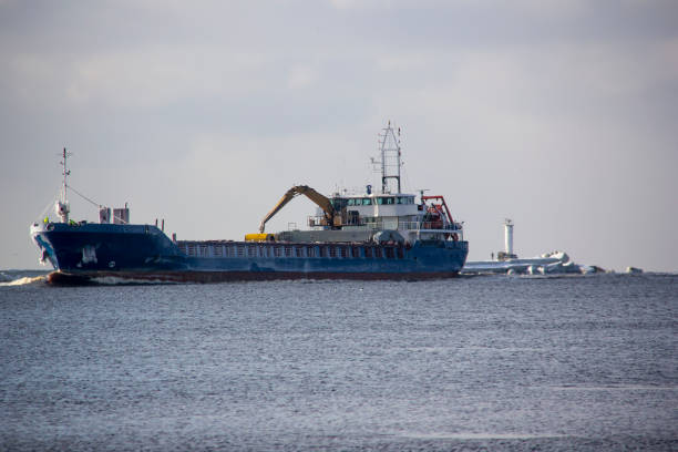 istock Cargo ship with ports crane bridge coming in port 926139328