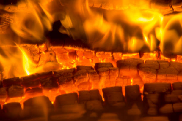 istock burning firewood coal closeup in the fireplace. 926139576