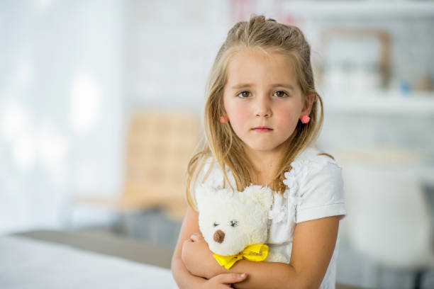 istock Girl Hugging Her Teddy Bear 926140524