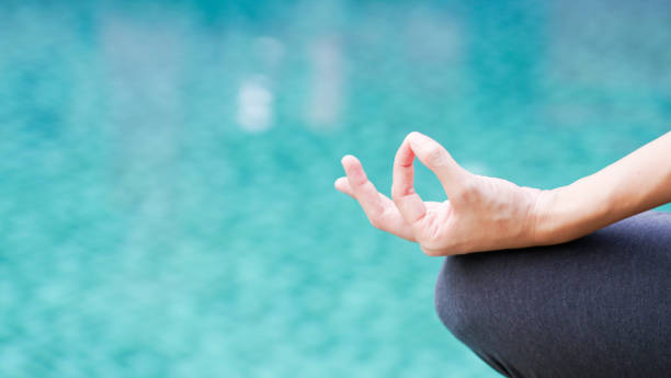 istock Gyan mudra hand yoga calm peace blue water background 926140564