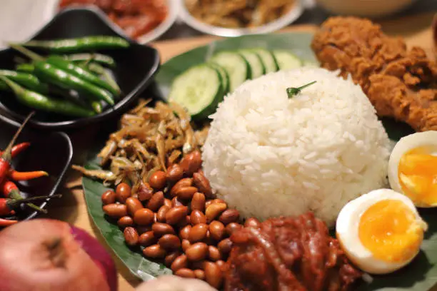 Photo of Nasi Lemak is a rice dish infused with coconut cream and laden with deep-fried fish or chicken wings.