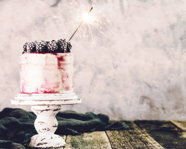 istock Birthday cake with sparkler on wooden vintage table 926147934
