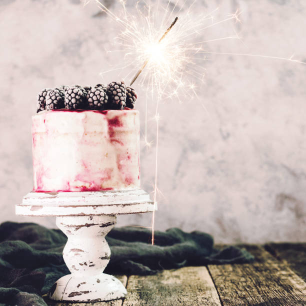 istock Birthday cake with sparkler on wooden vintage table 926149076