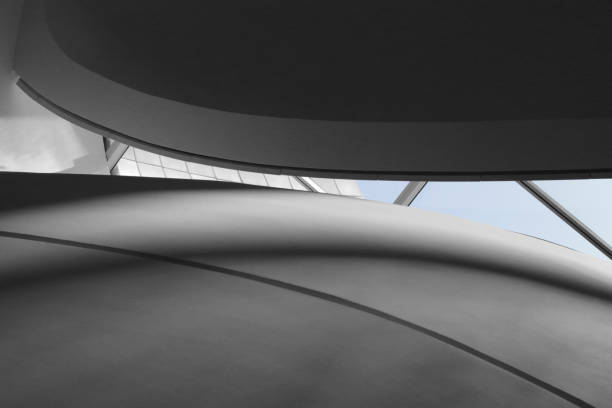 istock Underside view of curvilinear balconies. Digitally rendered interior fragment with backlight and shadows. Abstract modern architecture background with piece of sky in the middle. 926152818