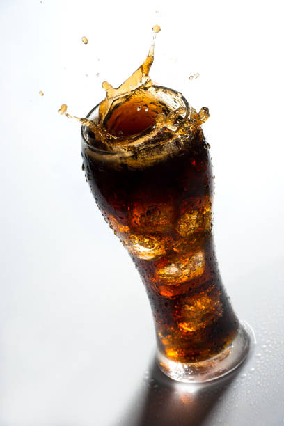 istock Ice splashing on a glass of a Cola drink 926159358