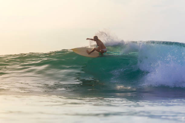 istock Surfer girl on a blue wave 926159492