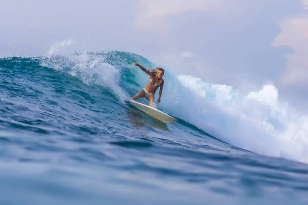 istock Surfer girl on a blue wave 926159570