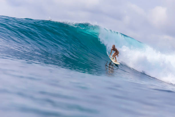 istock Surfer girl on a blue wave 926159694