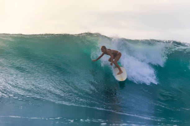 istock Surfer girl on a blue wave 926159700