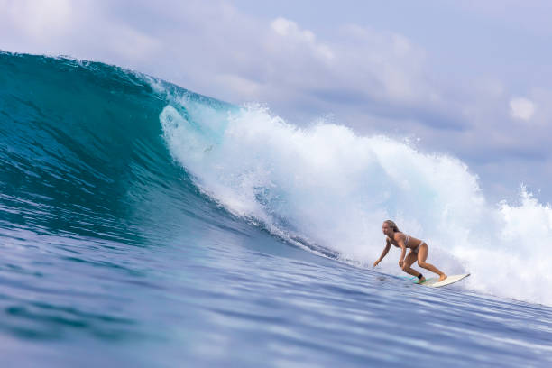 istock Surfer girl on a blue wave 926160190