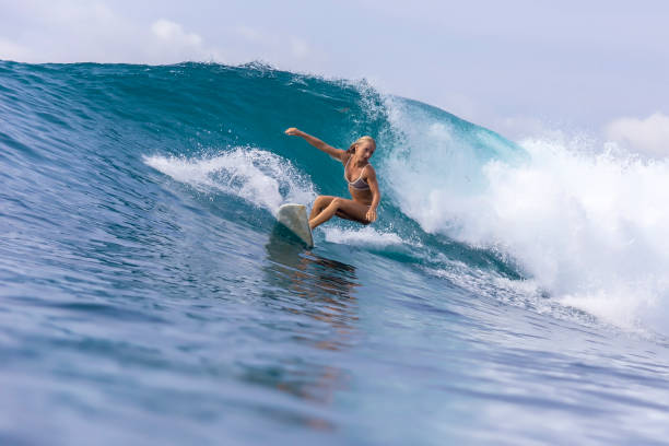 istock Surfer girl on a blue wave 926160194