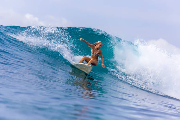 istock Surfer girl on a blue wave 926160278