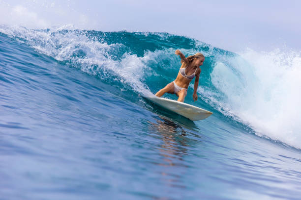 istock Surfer girl on a blue wave 926160404