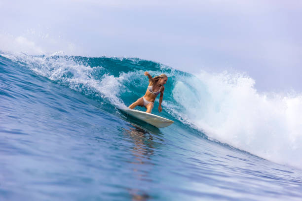 istock Surfer girl on a blue wave 926160406