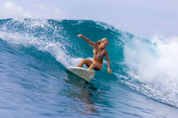 istock Surfer girl on a blue wave 926162602