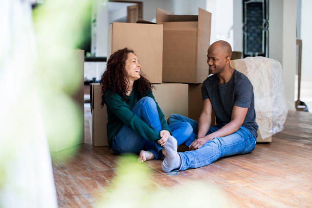 istock Happy couple sitting in new house 926168406