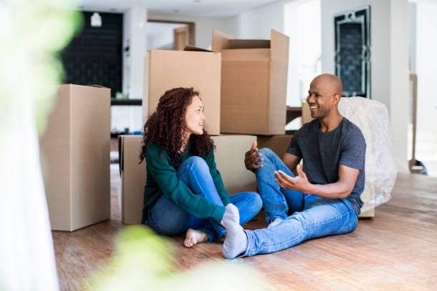 istock Couple talking while sitting in new house 926168426