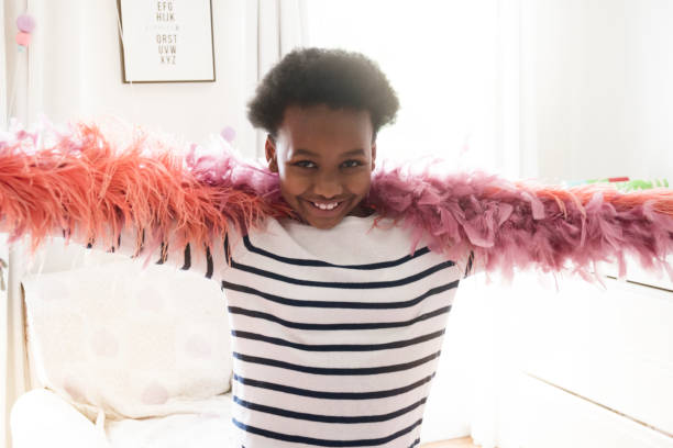 istock Girl dancing with feather boa at home 926168958