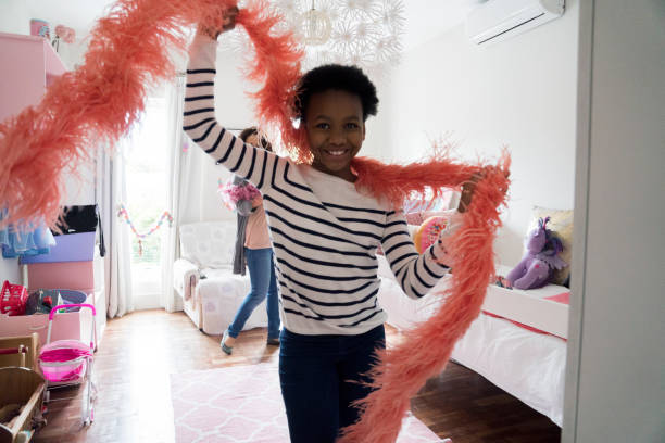 istock Girl dancing with feather boa at home 926170720