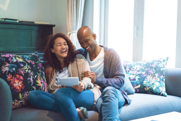 istock Happy couple using digital tablet on sofa at home 926171194